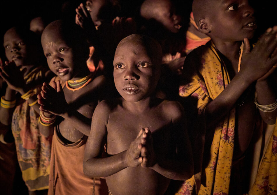 Children pray and sing during a nighttime prayer vigil for peace in Nakubuse, a small village near Kuron in South Sudan's Eastern Equatoria State.  The region has been plagued by cattle raiding and child abduction in recent years. The Catholic Church-sponsored Holy Trinity Peace Village, centered in Kuron, has worked for years to foster reconciliation and peace between the region's pastoralist communities.