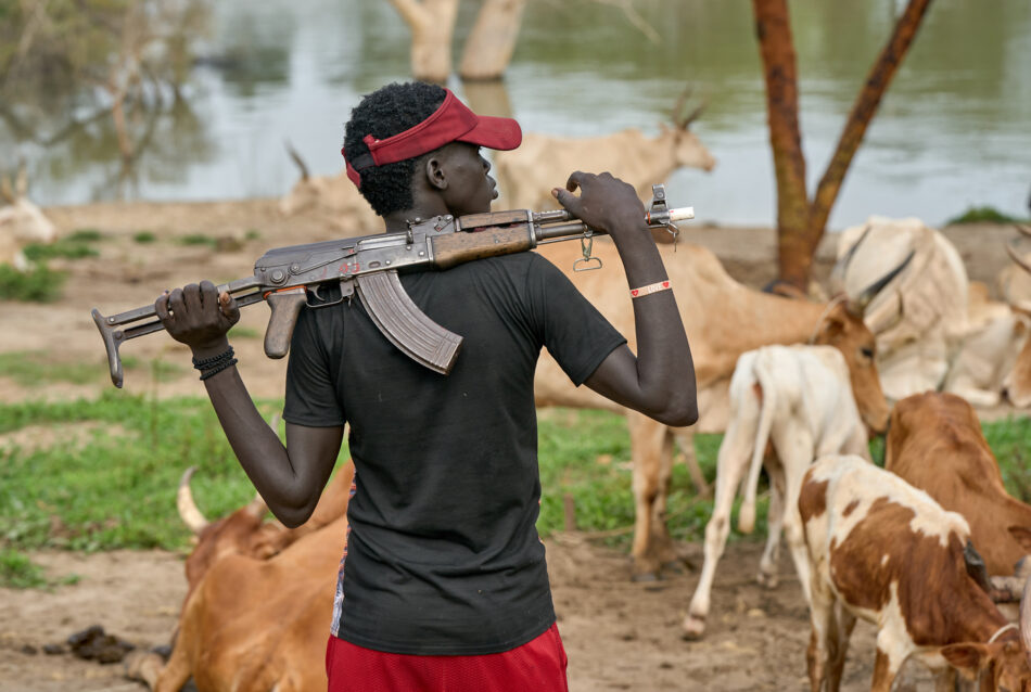 A cattle keeper holds an assault rifle in Mogok, South Sudan. Cattle raiding between neighboring tribes has long been a tradition in South Sudan, but the acquisition of high-powered weapons has turned the practice into a blood sport, and politicians and warlords have enlisted the armed cattle keepers as allies in acquiring and maintaining territory.