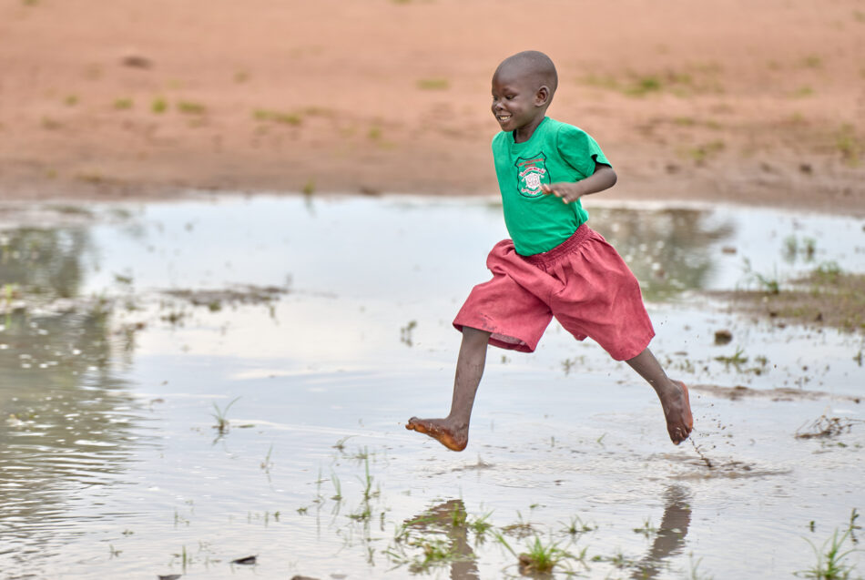 A boy runs through a puddle on his way to the Loreto Primary School in Maker Kuei, South Sudan.
